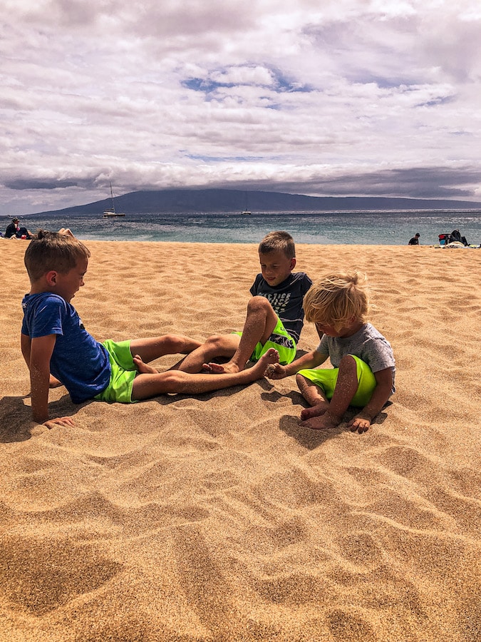Kids playing in the sand at Kaanapali Beach in Maui. 