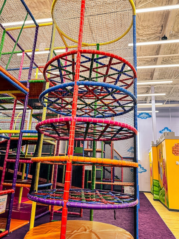 Climbing tower with circles to climb through that are different colors