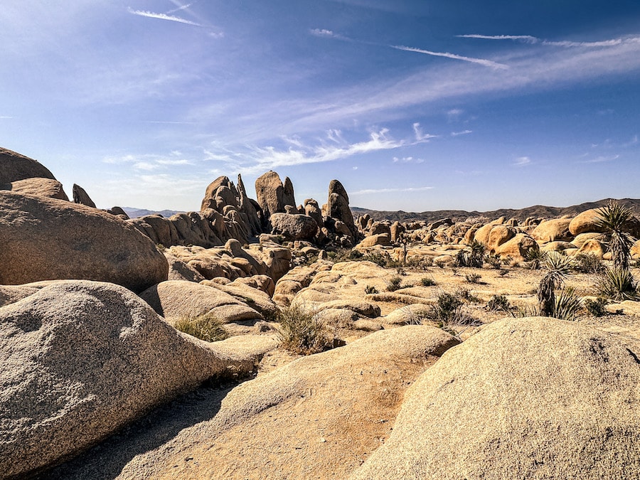 Large boulders in the desert with blue sky overhead