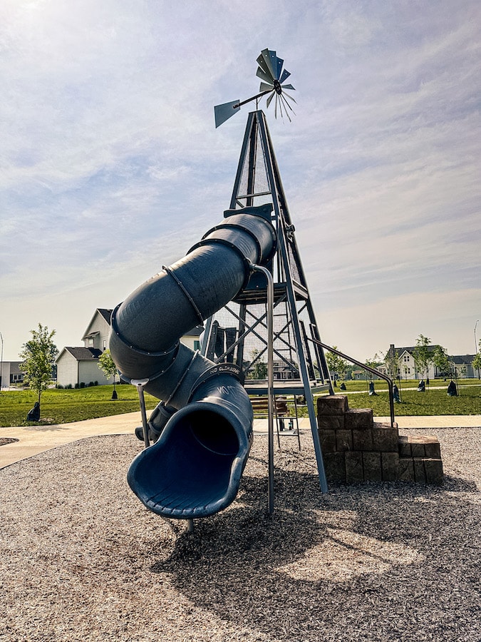 Large blue tube slide with a windmill on top.