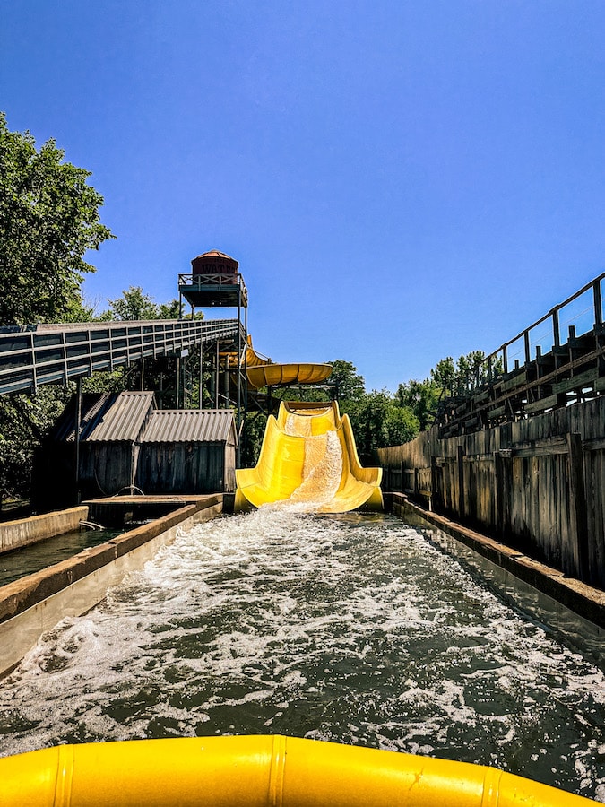 Saw Mill Splash water ride in a large yellow tube down a yellow slide.