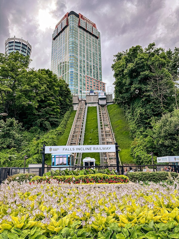 View of the Falls Incline Railway and its sign with the Embassy Suites Fallsview in the background.