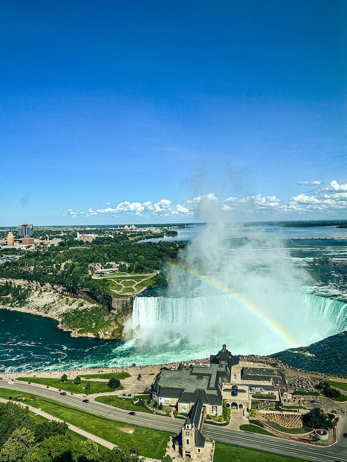 View of Horseshoe Falls from above with a rainbow plus a view of Table Rock Centre.
