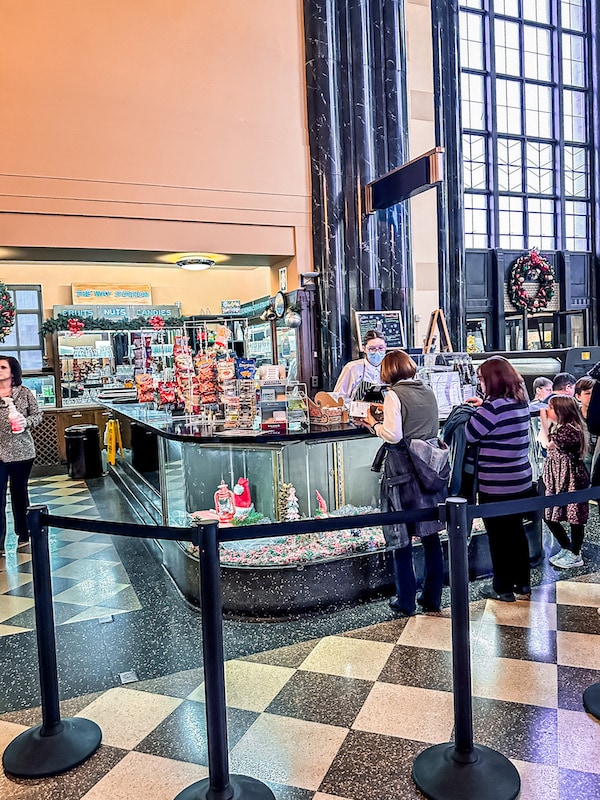 People standing in line to purchase treats at the soda fountain and candy shop inside of the Durham Museum in Omaha.