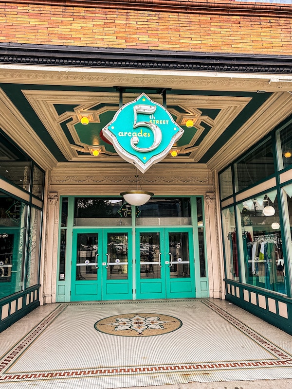 Exterior teal doors and sign for the 5th Street Arcade in downtown Cleveland.