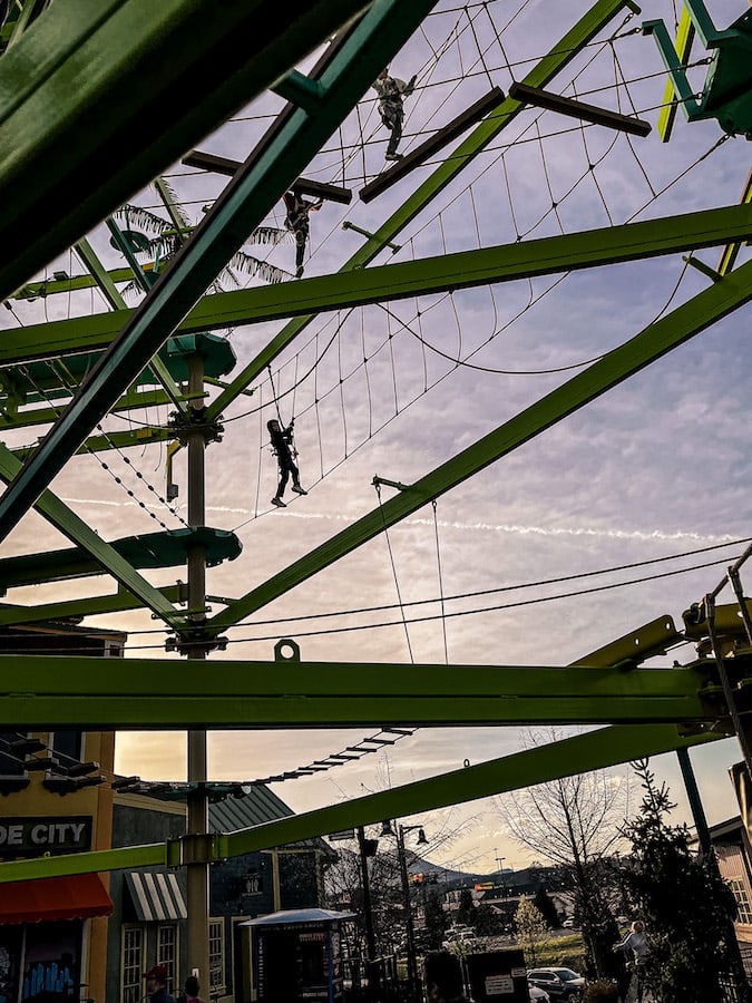 A person at the top of the ropes course at the Island in Pigeon Forge.