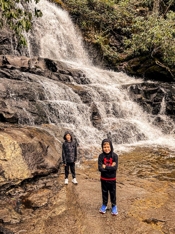 Two boys standing in front of Laurel Falls in Smoky Mountain National Park.