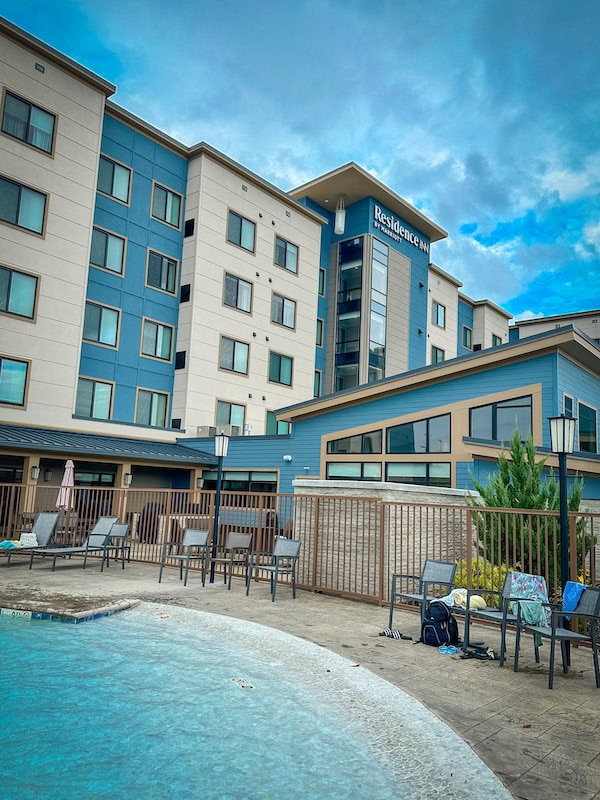 Daytime view of the exterior of the Residence Inn Pigeon Forge and the pool area.
