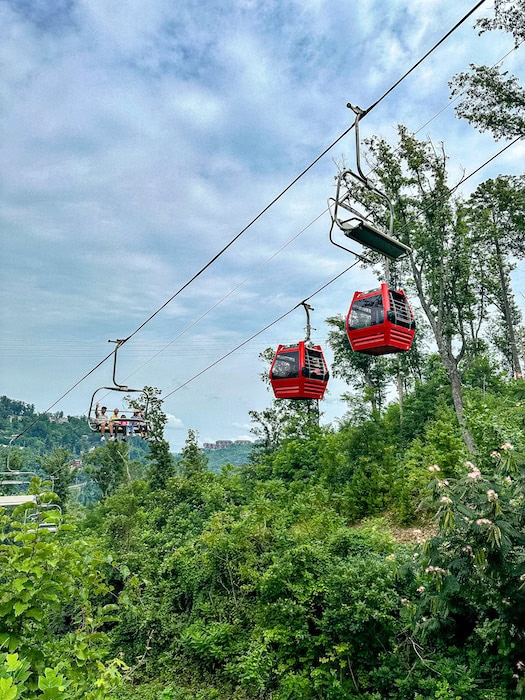 Two enclosed red gondolas and an open chairlift to get up and down from Anakeesta in Gatlinburg.