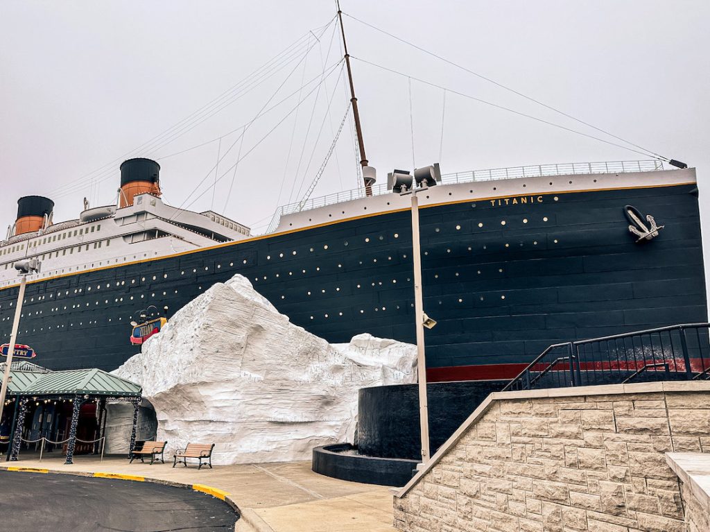 Exterior view of the Titanic Museum in Branson, Missouri, featuring a massive replica of the ship’s bow and smokestacks with an iceberg display at the entrance.