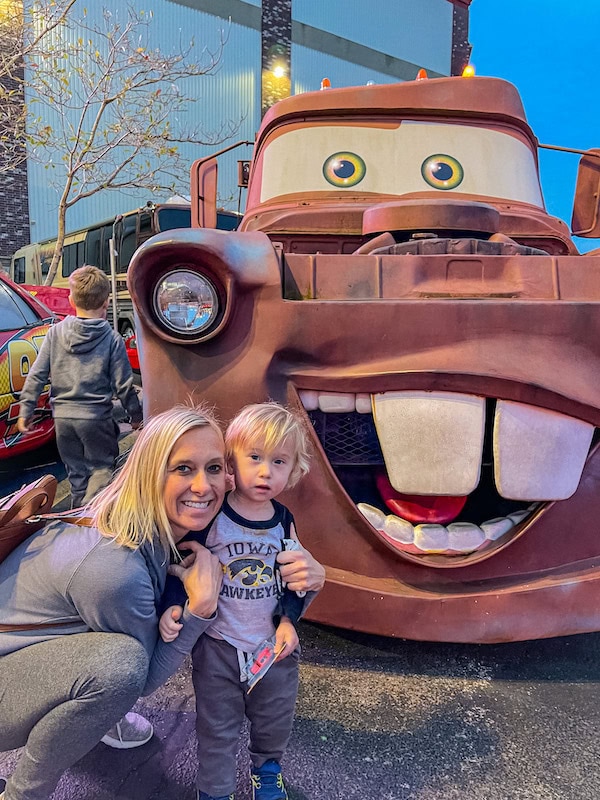 Mom and toddler posing with a large Tow Mater car outside of the Celebrity Car Museum in Branson, Missouri.