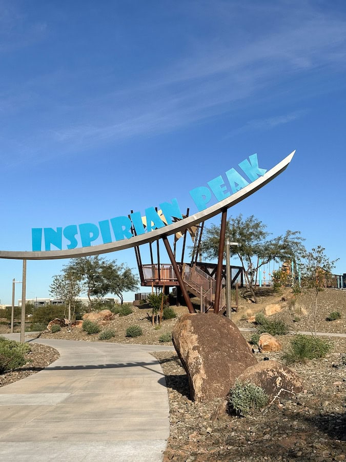 Inspirian Peak Park entrance sign with desert landscaping in Mesa, Arizona.