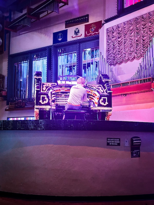 Organist playing the giant pipe organ at Organ Stop Pizza in Mesa, Arizona.