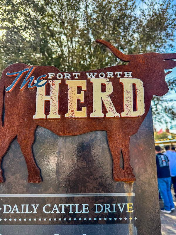 Fort Worth Herd sign with longhorn silhouette advertising the daily cattle drive at the Fort Worth Stockyards