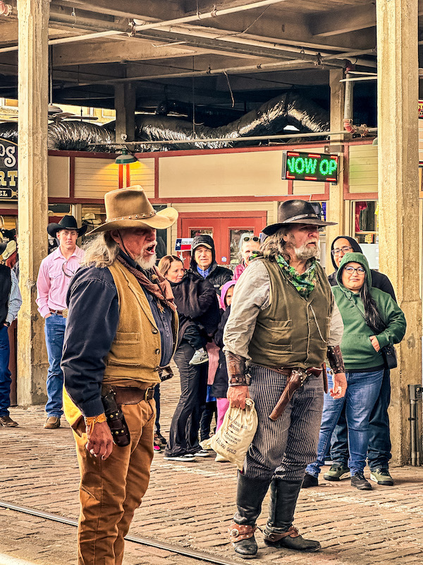 Old West gunfight show performers in cowboy costumes at the Fort Worth Stockyards