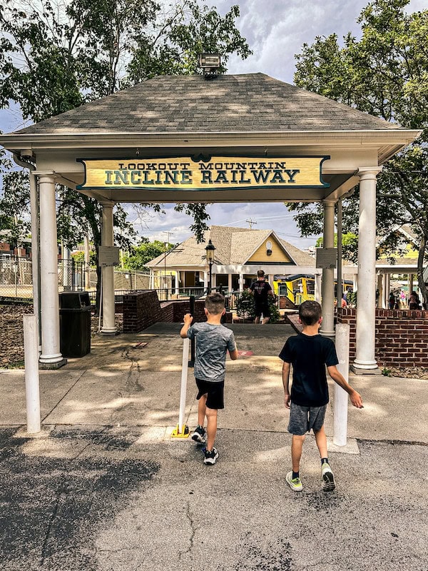2 boys walking under a walkway for the Lookout Mountain Incline Railway