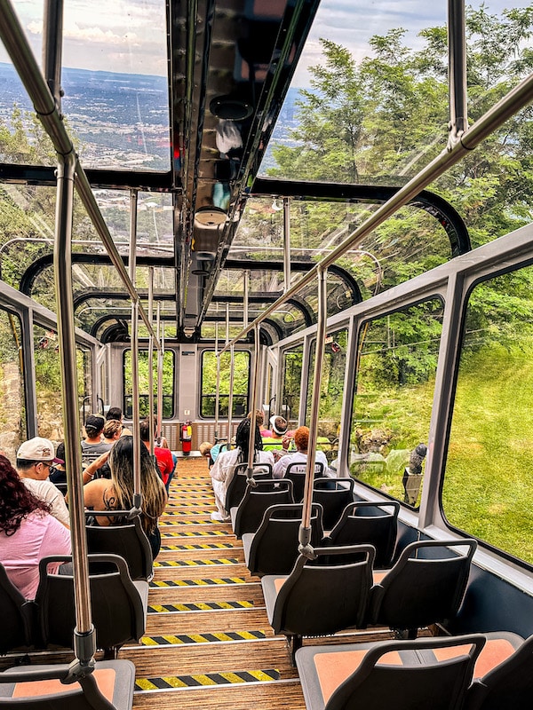 Inside of the incline railway car with windows for the roof and windows surrounding all sides of the car