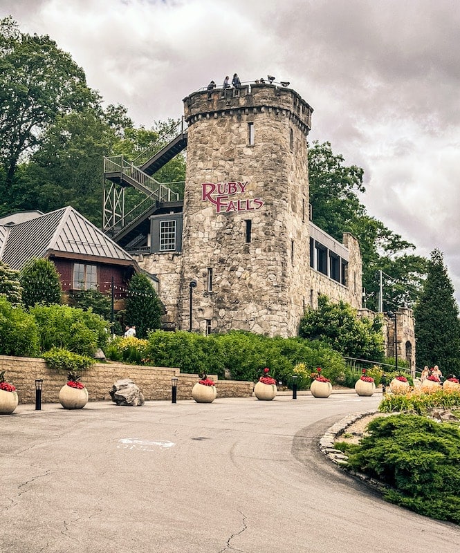 View of exterior of Ruby Falls and observation tower that looks like a castle.