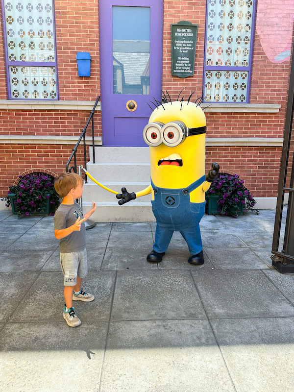 Young child meeting a Minion character in Minion Land at Universal Studios Hollywood.
