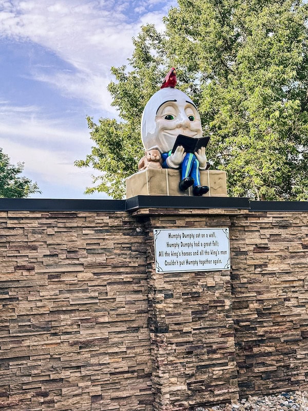 Humpty Dumpty statue sitting on a wall at Storybook Island in Rapid City, South Dakota.