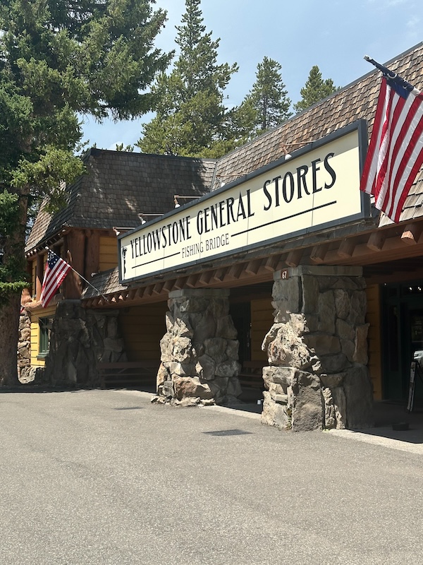 Exterior of the Yellowstone General Store at Fishing Bridge surrounded by pine trees in Yellowstone National Park.