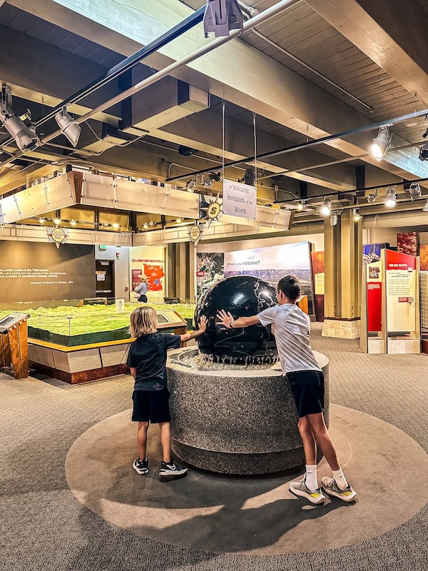 Two children exploring the geology exhibits inside the Canyon Visitor Education Center in Yellowstone National Park