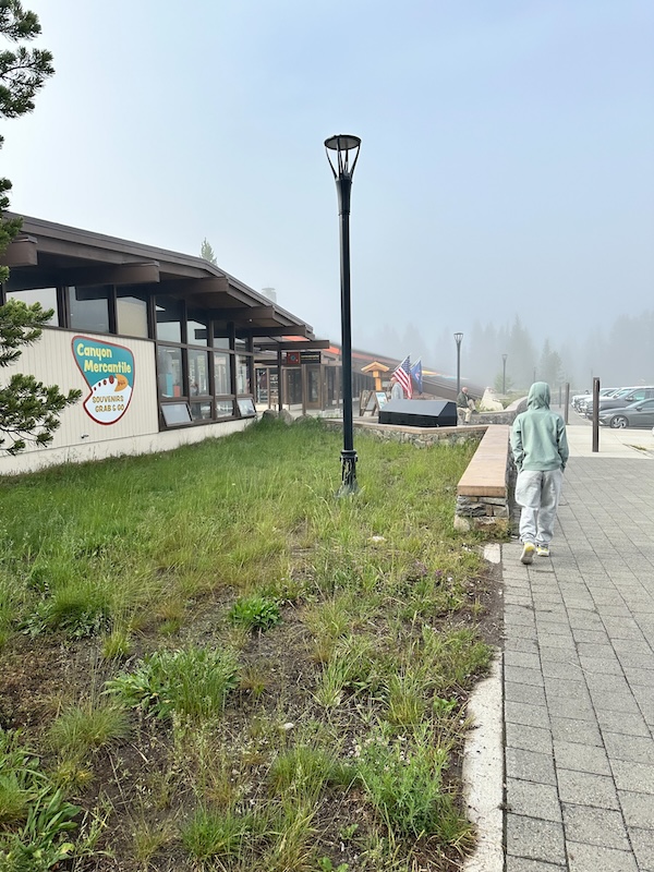 Child walking along the path outside Canyon Mercantile in Canyon Village at Yellowstone National Park